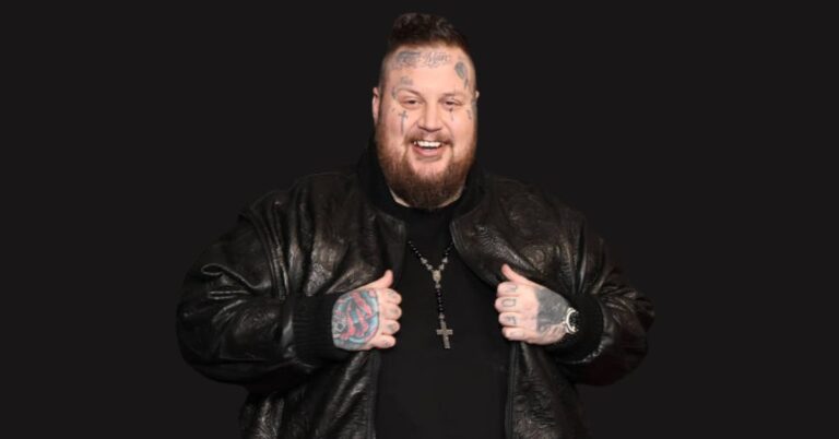 Jelly Roll performing on stage with a passionate crowd, representing his success in country rap and $12M empire.