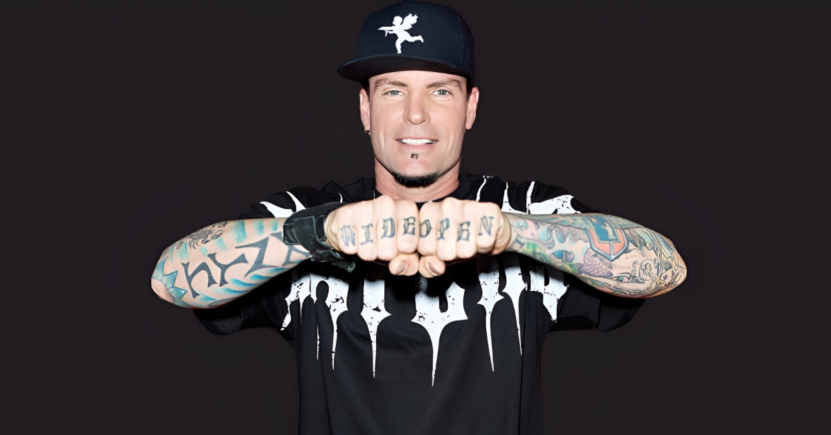 Vanilla Ice standing in front of luxury real estate properties, showcasing his 2025 net worth.